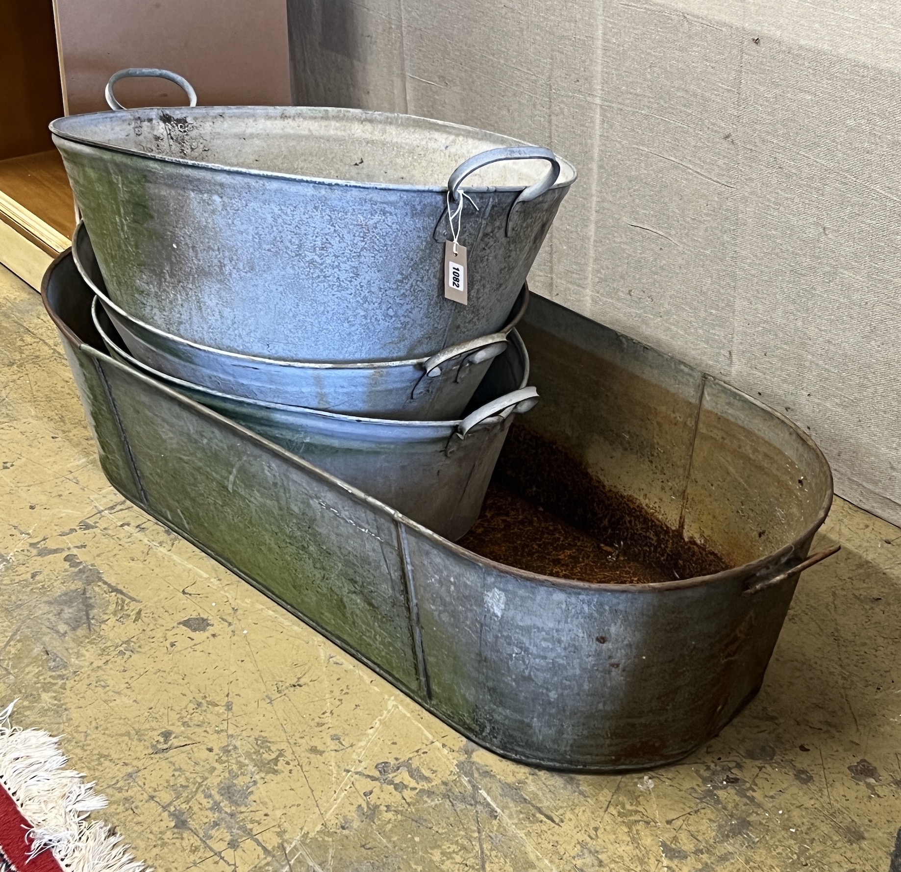 Four vintage galvanised containers, largest width 120cm, height 28cm